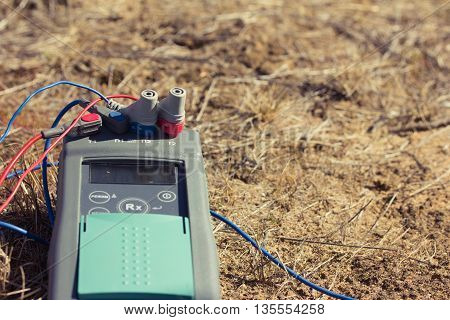 measurement of the earth. closeup of a three-phase electric cable