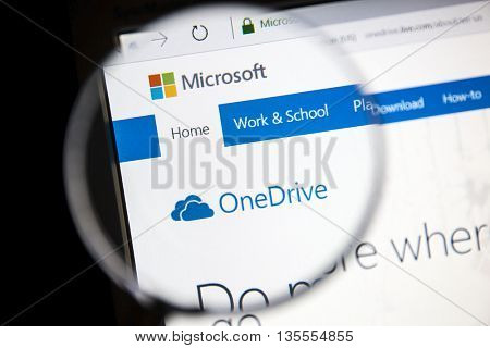 Ostersund, Sweden - June 23, 2016: Microsoft OneDrive website under a magnifying glass OneDrive is a file hosting service that allows users to sync files and later access them.