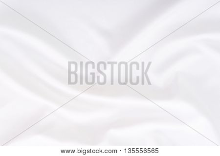 Close up of wrinkled white color fabric bed sheet texture background.