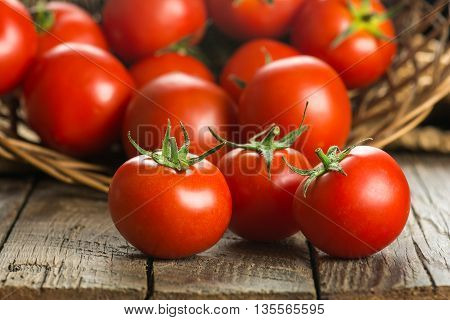 Ripe Tomatoes on wooden surface. Selective focus