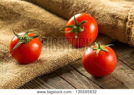 Ripe Tomatoes on wooden surface. Selective focus