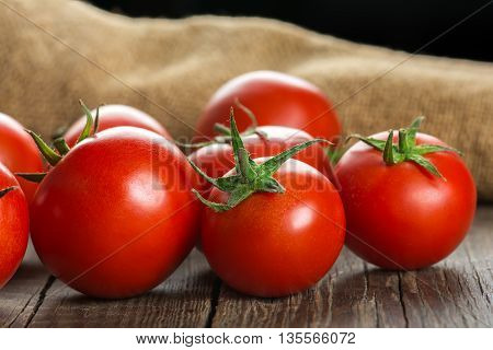 Ripe Tomatoes on wooden surface. Selective focus