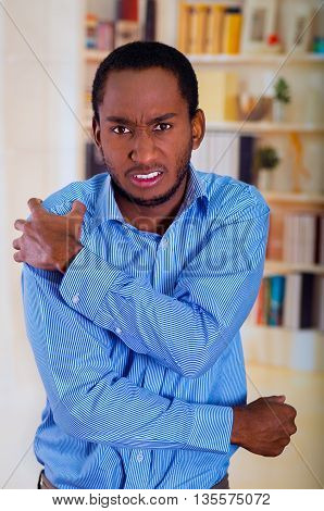 Shoulder pain demostrated in this picture, man holding with his hand.