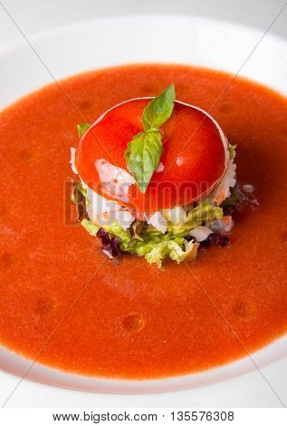 Tomato gaspacho soup on a white plate