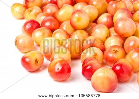 a lot of yellow cherries isolated on white background.