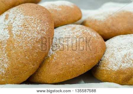 Selection of delicous bread buns lying in basket, as seen from above.