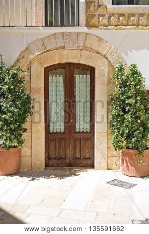 Wooden door. Alleyway of Turi. Puglia. Italy.