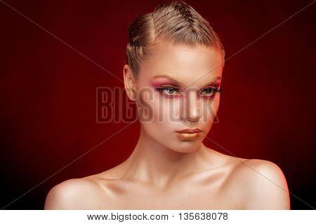 Girl With Red And Gold Make Up In Studio Photo