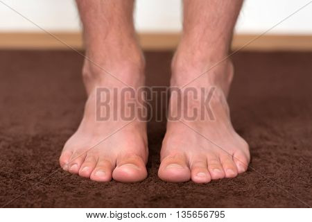 Itchy cold feet resting on the floor.