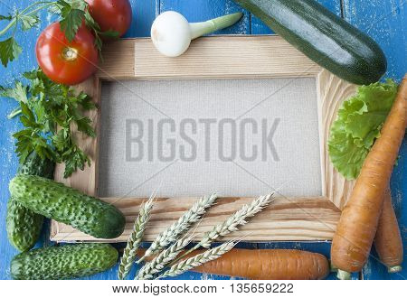 fresh vegetables on background canvas, cucumbers, tomatoes and carrots.