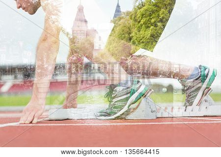 Side view of a man ready to race on running trac against canal in amsterdam