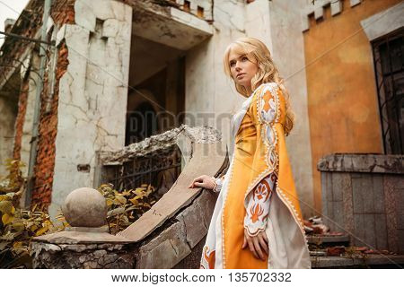 Beautiful lady with blond hairs in medieval dress