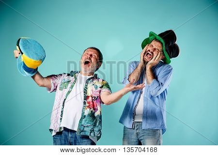 The two football fans with different emotions over blue background