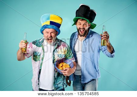 The two football fans over blue background