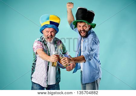 The two football fans over blue background