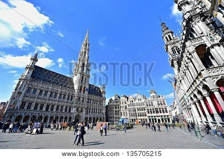 BRUSSELS BELGIUM - MARCH 16: Wide angle shot with tourists visiting the Grand Place on March 16 2016 in Brussels.