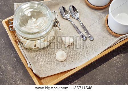 The meringues in glass jar on tray