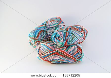 bales of wool in different colors with white background