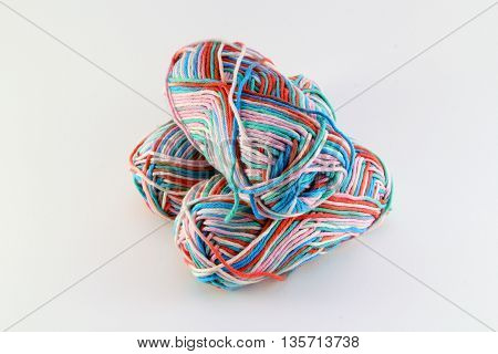 bales of wool in different colors with white background
