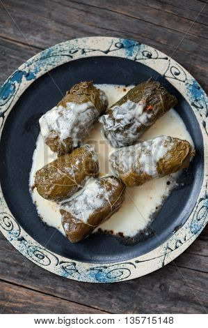 A plate with Romanian sarmale - stuffed vine leaves
