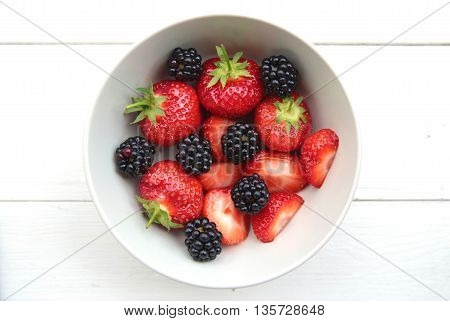 A Bowl Of Delicate Strawberries And Blackberries