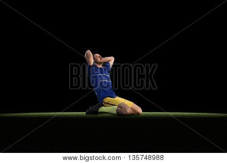 Frustrated soccer player in blue uniform isolated on football training on green grass