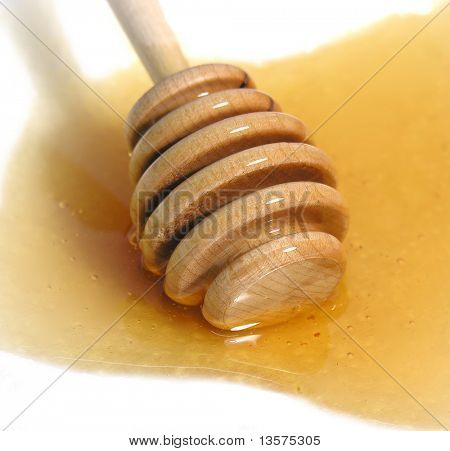 A photo of a honey dripper in some honey