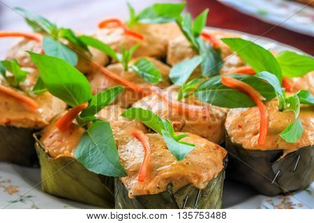 Thai steamed curry fish in banana leaf cups decorated with basil leaf (Hor Mok Pla)