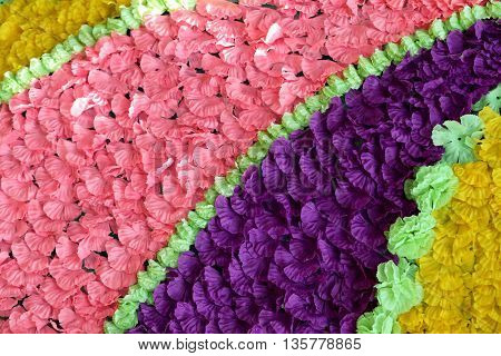 Background of colorful fake flowers that decorated the backdrop for the design of nature.