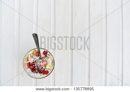 top view icecream in a cup with strawberry pistachio coconut
