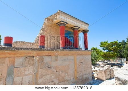 Knossos palace with charging bull fresco on the background on the Crete island Greece.