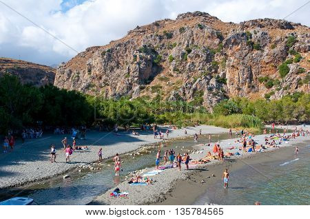 CRETEGREECE-JULY 23:Tourists have a rest on the Preveli Beach on July 232014 on Crete Greece. The beach of Preveli is situated 40 km south of the main town and is the most idyllic beach in Crete.