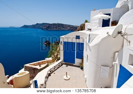 Oia town apartments on the lip of the volcanic crater on the island of Thera also known as Santorini Greece.