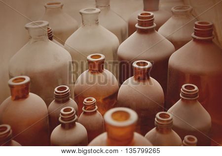 antique  bottles covered with dust in pharmaceutical laboratory