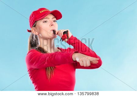 Lifeguard Woman In Cap On Duty Blowing Whistle.