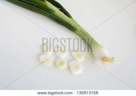 Fresh raw spring onions on a white background