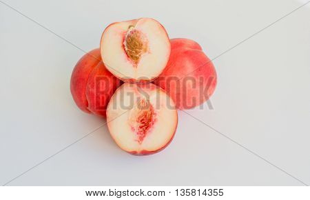 ripe white flesh juicy peaches on white