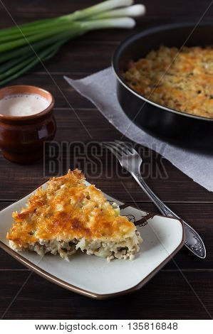 A portion of casserole with cheese cauliflower and chicken