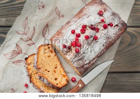 Homemade cake with dried apricots and raisins, decorated with cranberries.