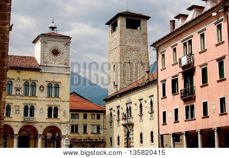 Belluno Italy - June 8 2006: Late 15th century Rector's Palace (left) and Renaissance houses with a stone watch tower in the Piazza dei Duomo