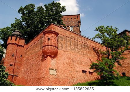 Krakow Poland - June 10 2010: Imposing bastion with small round watch tower on the medieval defensive Wawel Hill defensive walls