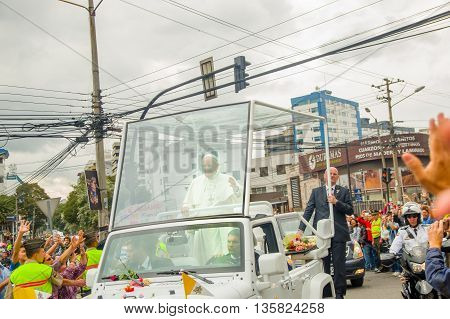 QUITO, ECUADOR - JULY 7, 2015: Pope Francisco crossing Quito city in his popemobile, security on the sides.