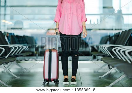 Silhouette of passenger in an airport lounge waiting for flight aircraft