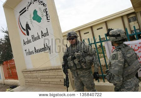KIRKUK, IRAQ - FEBRUARY 2, 2007: Unidentified Iraqi soldiers and US soldiers stands guard on a check point on February 2, 2007 in Kirkuk, Iraq.