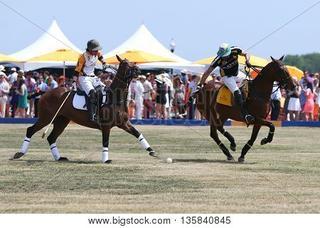 JERSEY CITY, NJ-MAY 30: Rico Mansur (R) handles the ball as Edward Hartman gives chase during a polo match at the Veuve Clicquot Polo Classic at Liberty State Park on May 30, 2015 in Jersey City, NJ.