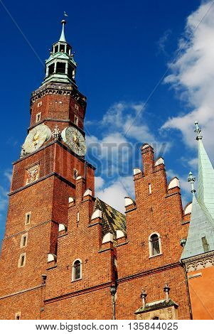 Wroclaw Poland - June 13 2010: Bell-Clock tower and brick gables of the late 15th to early 16th century Ratusz (Town Hall)