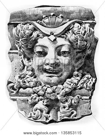 Relief sculpture of a head of a woman on the wall of the municipal council chamber in Paris, France. Vintage engraving.