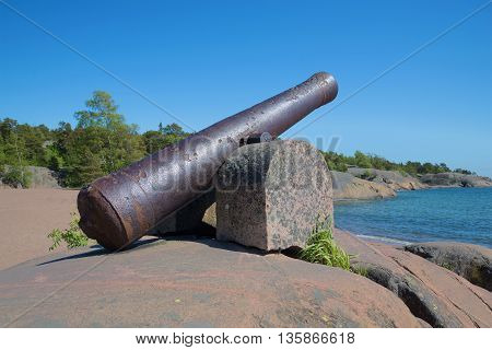 An old cannon on the cliffs of the peninsula of Hanko, sunny day. Finland