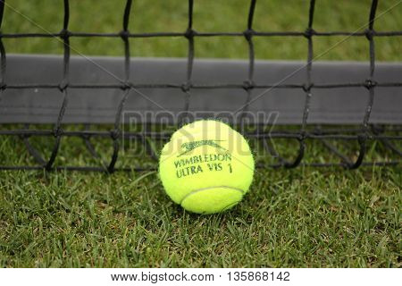 NEW YORK - JULY 21, 2015: Slazenger Wimbledon Tennis Ball on grass tennis court. Slazenger Wimbledon Tennis Ball exclusively used and endorsed by The Championships, Wimbledon