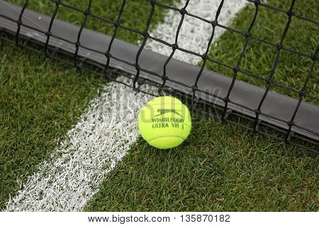 NEW YORK - JULY 21, 2015: Slazenger Wimbledon Tennis Ball on grass tennis court. Slazenger Wimbledon Tennis Ball exclusively used and endorsed by The Championships, Wimbledon